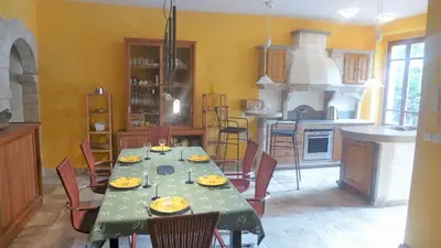 a dining room with a table and chairs in a kitchen at Ferienhaus Le Château in Armissan
