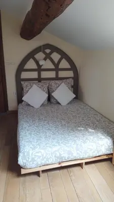 a bed with two pillows on it in a room at Ferienhaus Le Château in Armissan