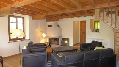 a living room with leather furniture and a fireplace at Ferienhaus Le Château in Armissan