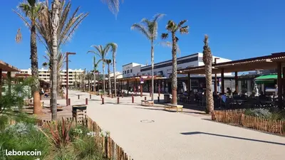 a street with palm trees and a building at Designer Haus in Armissan