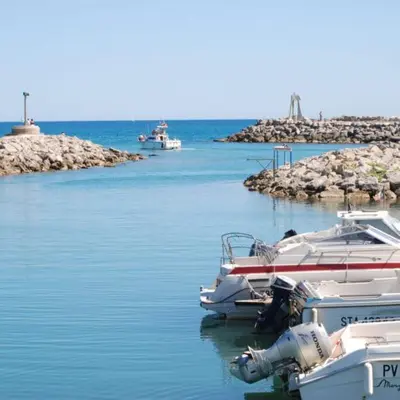 a couple of boats docked in the water at Designer Haus in Armissan
