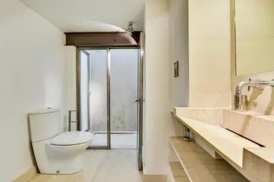 a bathroom with a toilet and a sink and a shower at Designer Haus in Armissan