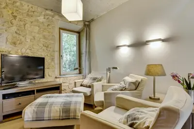 a living room with white furniture and a flat screen tv at Designer Haus in Armissan