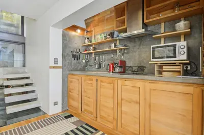 a kitchen with wooden cabinets and a microwave at Designer Haus in Armissan