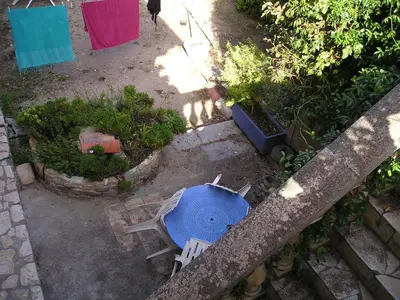 an overhead view of a blue umbrella in a garden at GITE PAPY ALBERT in Gruissan