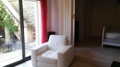 a white chair in a room with a window at GITE PAPY ALBERT in Gruissan