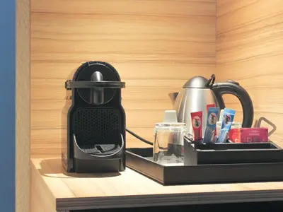 a black tea kettle sitting on top of a kitchen counter at Novotel Narbonne Sud A9/A61 in Narbonne