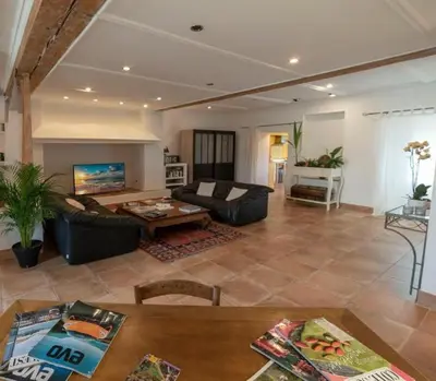 a living room with a couch and a table at Hibiscus House in Carcassonne