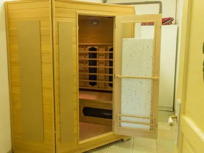 a wooden cabinet in a kitchen with a wine cellar at Stay, Saint-André-de-Roquelongue in Saint-André-de-Roquelongue