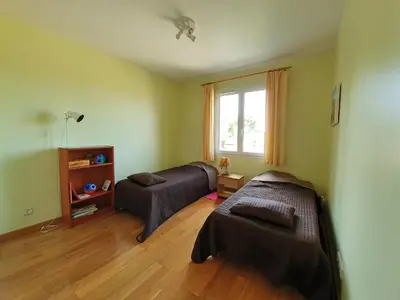 a living room with two beds and a window at Stay, Saint-André-de-Roquelongue in Saint-André-de-Roquelongue