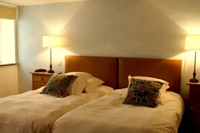 two beds sitting next to each other in a room at Domaine de Rasigous in Saint-Affrique-les-Montagnes