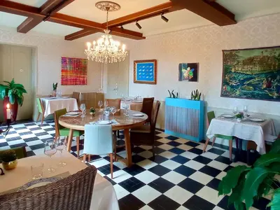 a restaurant with tables and chairs and a chandelier at Domaine de Rasigous in Saint-Affrique-les-Montagnes