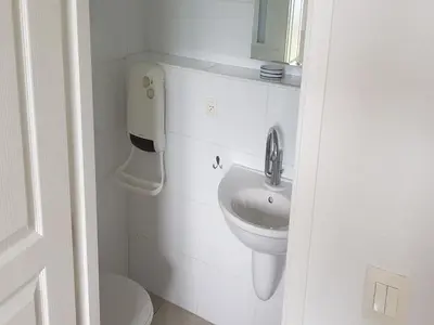a white bathroom with a sink and a toilet at Modern villa in Camplong with private pool in Félines-Minervois