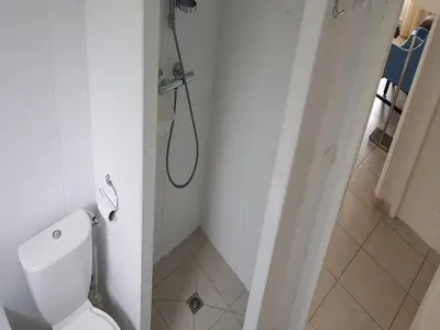 a white bathroom with a shower and a toilet at Modern villa in Camplong with private pool in Félines-Minervois