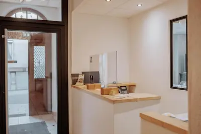 a bathroom with a counter and a mirror at Hôtel De France in Chalabre
