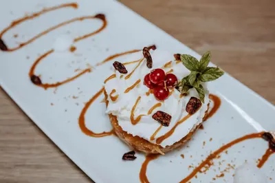 a dessert on a white plate on a table at Hôtel De France in Chalabre