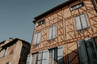 a building with many windows on the side of it at Hôtel De France in Chalabre