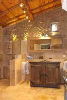 a large bathroom with a shower and a sink at Bergerie Marcel in Durban-Corbières