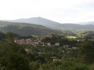 a town in the middle of a valley with mountains at Bergerie Marcel in Durban-Corbières