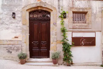 a door to a building with two potted plants in front at La Résidence de Gérard in Montréal
