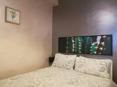 a bedroom with a bed with a tv on the wall at CASA BLANCA à SIGEAN-GÎTE in Sigean