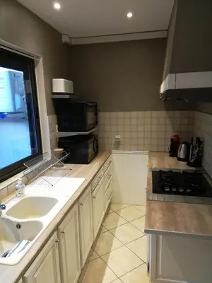 a kitchen with a sink and a stove top oven at CASA BLANCA à SIGEAN-GÎTE in Sigean