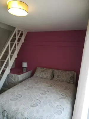 a bedroom with a bed and a staircase at CASA BLANCA à SIGEAN-GÎTE in Sigean