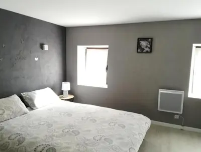 a bedroom with a large bed and two windows at CASA BLANCA à SIGEAN-GÎTE in Sigean