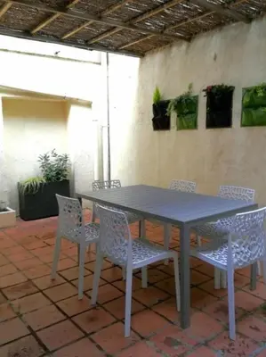a gray table and chairs on a patio at CASA BLANCA à SIGEAN-GÎTE in Sigean