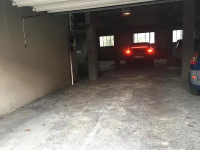 an empty garage with a truck parked in it at Appart Aux deux Colombes avec Balcon et Garage in Pamiers