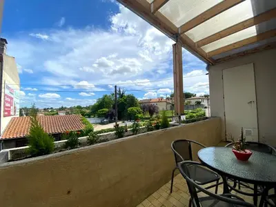 a patio with a table and chairs on a balcony at Appart Aux deux Colombes avec Balcon et Garage in Pamiers