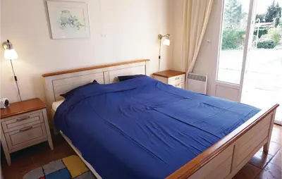 a bedroom with a blue bed and a window at Stunning Home In Prades Sur Vernazobre in Prades-sur-Vernazobre