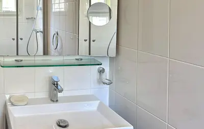 a white bathroom with a sink and a mirror at Stunning Home In Prades Sur Vernazobre in Prades-sur-Vernazobre