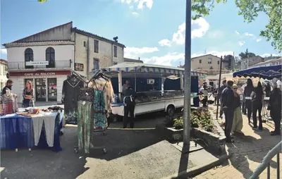 a group of people standing around a market with a food truck at Stunning Home In Prades Sur Vernazobre in Prades-sur-Vernazobre