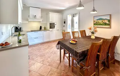 a kitchen and dining room with a table and chairs at Stunning Home In Prades Sur Vernazobre in Prades-sur-Vernazobre