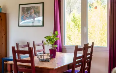 a dining room table with chairs and a plant on it at Amazing Home In Prades Sur Vernazobre in Prades-sur-Vernazobre