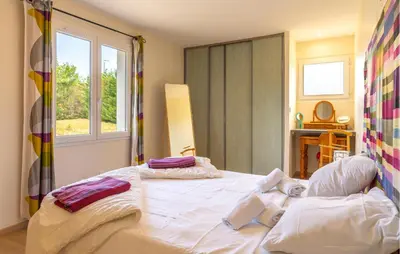 a bedroom with a large white bed and a window at Amazing Home In Prades Sur Vernazobre in Prades-sur-Vernazobre