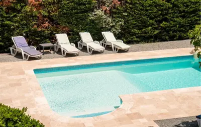 a swimming pool with lounge chairs and a group at Amazing Home In Prades Sur Vernazobre in Prades-sur-Vernazobre