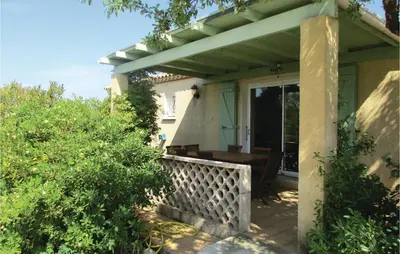 a porch of a house with a wooden table at Amazing Home In Cruzy in Cruzy