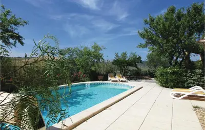 a swimming pool in a yard with chairs and trees at Amazing Home In Cruzy in Cruzy