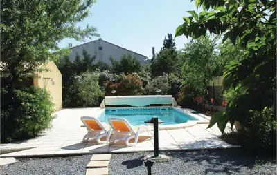 a patio with two chairs and a swimming pool at Amazing Home In Cruzy in Cruzy