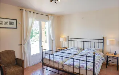 a bedroom with a bed and a window at Beautiful Home In Prades Sur Vernazobre in Prades-sur-Vernazobre