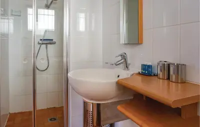 a bathroom with a white sink and a shower at Beautiful Home In Prades Sur Vernazobre in Prades-sur-Vernazobre