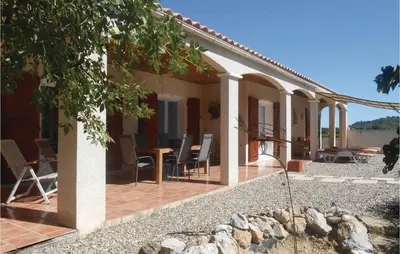 an external view of a house with a patio at Beautiful Home In Prades Sur Vernazobre in Prades-sur-Vernazobre