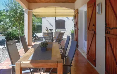 a wooden table and chairs on a patio at Beautiful Home In Prades Sur Vernazobre in Prades-sur-Vernazobre