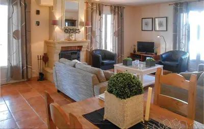 a living room with a couch and a fireplace at Beautiful Home In Prades Sur Vernazobre in Prades-sur-Vernazobre