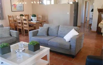 a living room with a couch and a table at Beautiful Home In Prades Sur Vernazobre in Prades-sur-Vernazobre