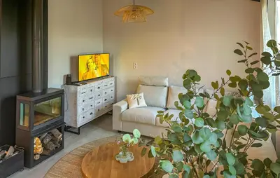 a living room with a couch and a tv and a table at Awesome Home In Prades Sur Vernazobre in Prades-sur-Vernazobre