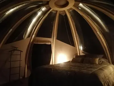 a bed in a room with a window at Le Wigwam du Fassac in Saint-Julien-du-Puy
