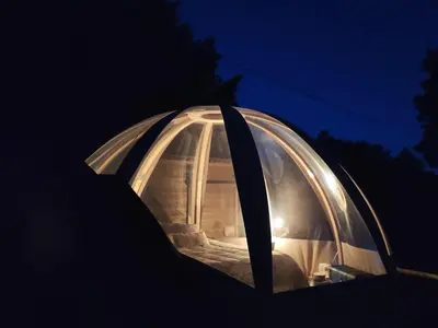 a domed object is lit up at night at Le Wigwam du Fassac in Saint-Julien-du-Puy